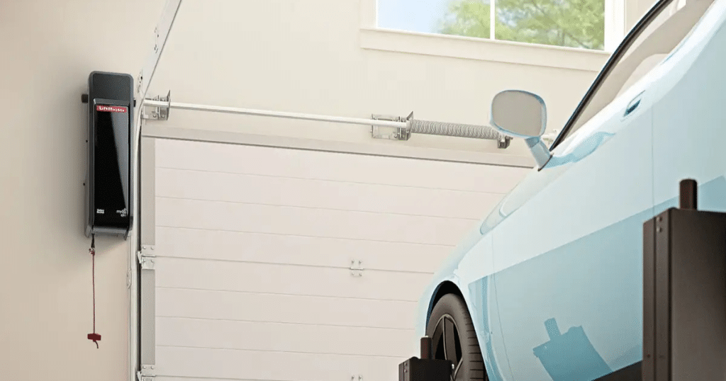 Garage door opener beside a blue car.