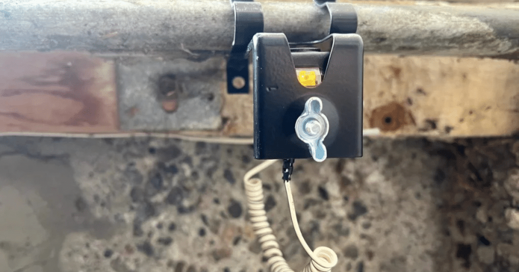 Garage door sensor with amber indicator light.