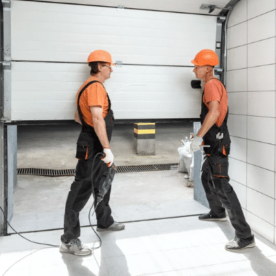 Workers operating a garage door system.