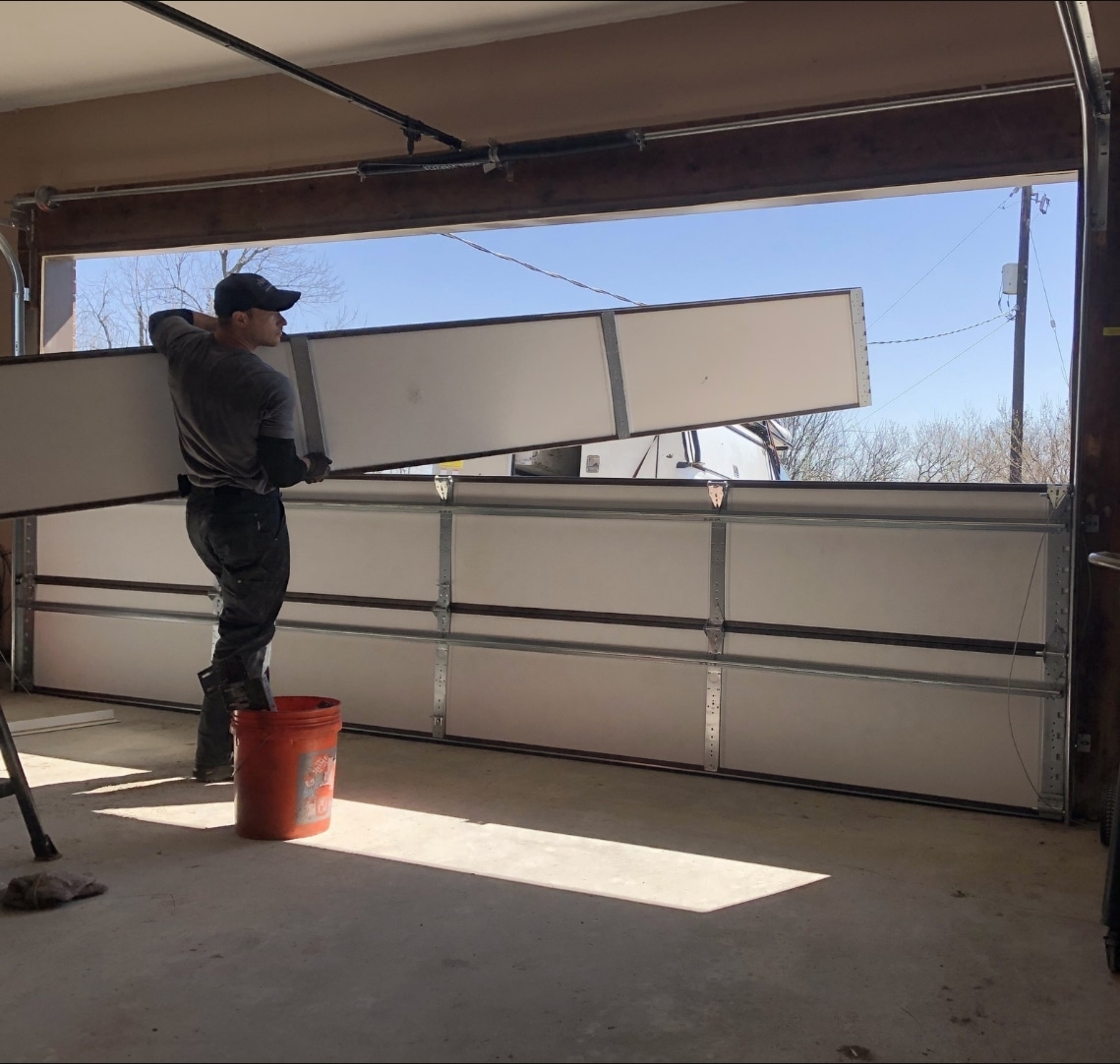 people installing a garage door